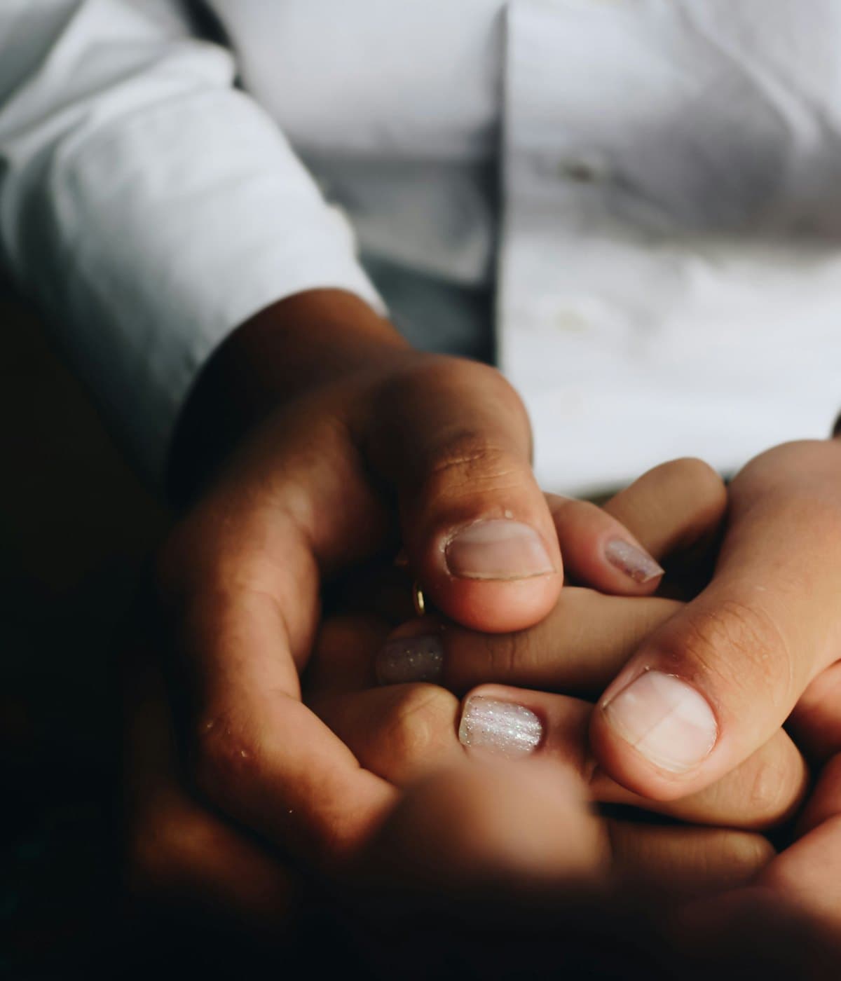 A patient's hands held gently — compassionate care at Leancare Health